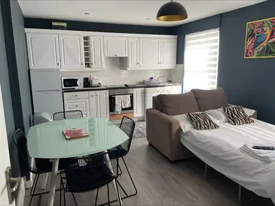 a living room with a couch and a table at Arrandale Apartments in Douglas