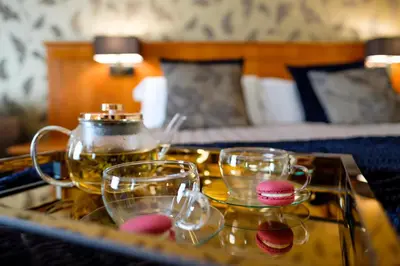 a tray with two glasses and a tea pot on a table at The Gretna Chase Hotel in Gretna