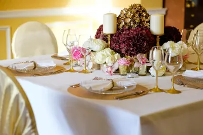 a white table with candles and flowers on it at The Gretna Chase Hotel in Gretna