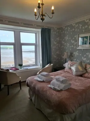 a bedroom with a bed with towels on it at Balcary Bay Country House Hotel in Auchencairn