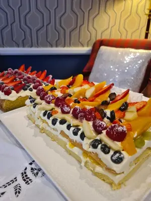a cake with fruit on it on a plate at Balcary Bay Country House Hotel in Auchencairn