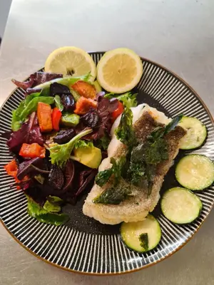 a plate of food with a salad and meat and vegetables at Balcary Bay Country House Hotel in Auchencairn
