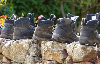 a group of boots sitting on top of a rock at Bridge End Farm Cottages in Boot