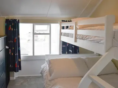 a bedroom with a bunk bed and a couch at Ludlow Bank in Coulderton