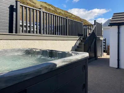 a hot tub on the side of a house at Ludlow Bank in Coulderton