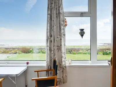 a room with a window with a desk and a table at Craignair in Port William