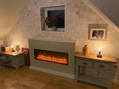 a living room with a fireplace in the wall at Latrigg View in Keswick