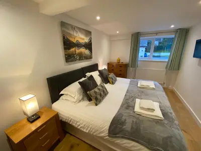 a bedroom with a large bed and a window at Latrigg View in Keswick