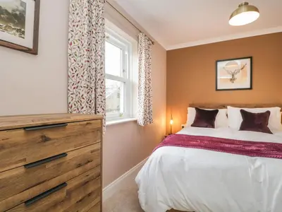 a bedroom with a bed and a window at The Crook in Penrith