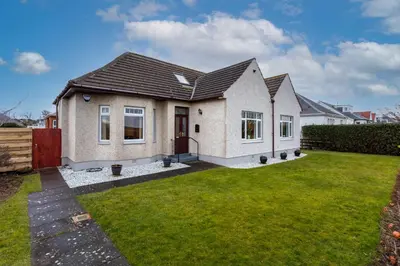 a house with a lawn in front of it at Sunset View - Donnini Apartments in Ayr