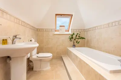 a bathroom with a sink toilet and a bath tub at Sunset View - Donnini Apartments in Ayr