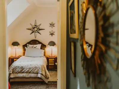 a bedroom with a bed with two lamps and a mirror at Fern Forest House- Uk31047 in Portpatrick