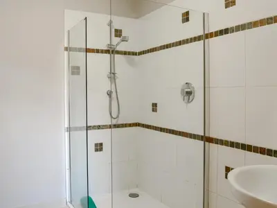 a bathroom with a shower and a sink at Laird House in Lochmaben