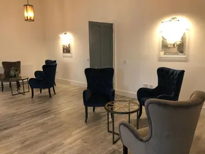 a waiting room with chairs and a table at East Church House, Unique 9 bedroom Church, Historic Market Town. in Strathaven