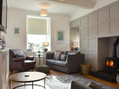a living room with a couch and a fireplace at Loanmhor in Kilmory