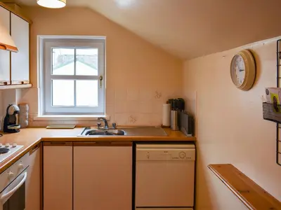 a small kitchen with a sink and a window at Walkers Retreat in Keswick