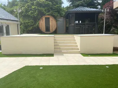 a house with a barrel and a yard with green grass at Kirkwirral Bed & Breakfast in Dumfries