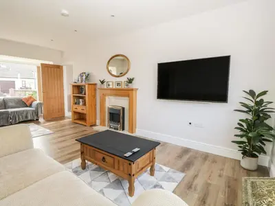 a living room with a flat screen tv on a wall at The Croft Bungalow in Wigton