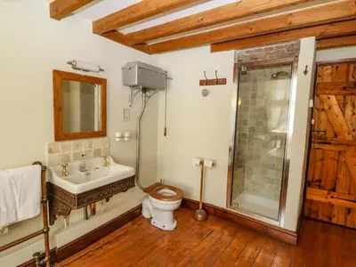 a bathroom with a toilet and a sink and a shower at Plosh House in Keswick