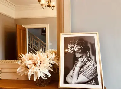 a picture of a woman is next to a mirror at Stunning Period Townhouse with Garden, Walking Distance to Town in Dumfries