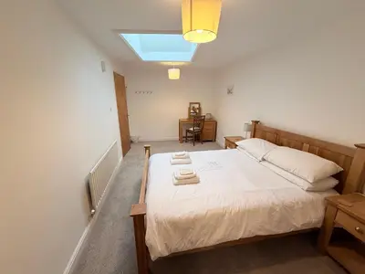 a bedroom with a bed with two towels on it at Low Haven in Keswick