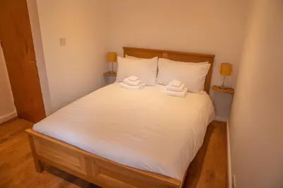 a bedroom with a bed with two towels on it at Low Haven in Keswick