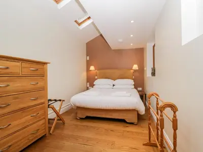 a small bedroom with a bed and a dresser at Beckwood in Penrith