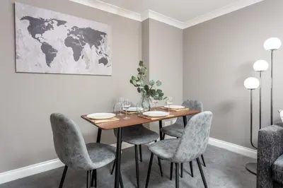 a dining room with a table and chairs at Elms Way No33 – Donnini Apartments in Ayr
