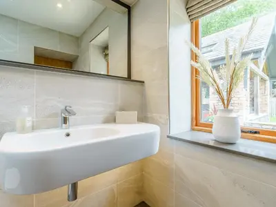 a white sink in a bathroom with a window at Herdwick View - Uk33668 in Bassenthwaite Lake