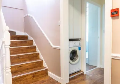a laundry room with a washer and dryer at Apartment 16 in Castle Douglas