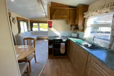 a kitchen and living room of a caravan at Caravan - Sleeps 4 - Pet friendly - Parking in Newton Stewart