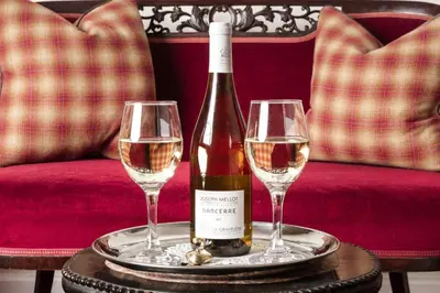 a bottle of wine and two glasses on a table at North West Castle Hotel in Stranraer