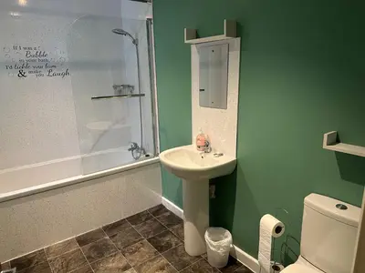 a bathroom with a sink and a shower and a toilet at 3 Dialknowe Holiday Cottage - Wanlockhead - 3 Bedrooms in Wanlockhead
