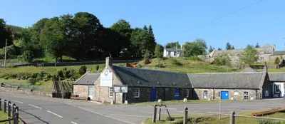 an old stone building on the side of a road at 3 Dialknowe Holiday Cottage - Wanlockhead - 3 Bedrooms in Wanlockhead