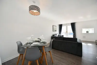 a living room with a table and a couch at Mews House in Ayr