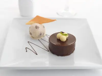 a chocolate cake sitting on top of a white plate at Fernhill Hotel in Portpatrick