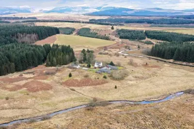an aerial view of a farm in a field at Maberry Cottage in Bargrennan