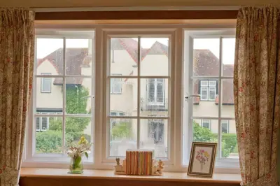 a window with a vase of flowers on a window sill at Troon Arts & Crafts Period Home Golf Beach in Troon