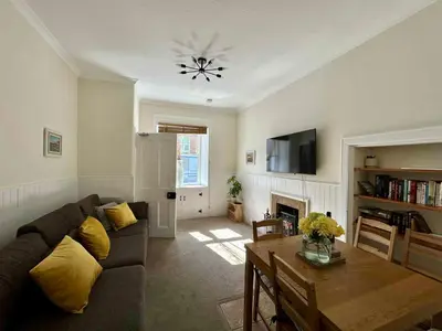 a living room with a couch and a table at 4 bedroom townhouse Kirkcudbright in Kirkcudbright