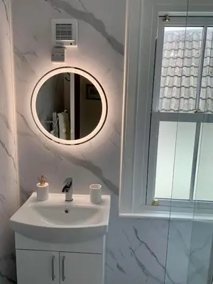 a bathroom with a white sink and a mirror at 4 bedroom townhouse Kirkcudbright in Kirkcudbright