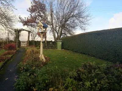 a bird house on a pole in the grass at 2 Mellfell View in Penrith
