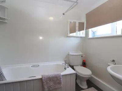 a bathroom with a tub and a toilet and a sink at 2 Mellfell View in Penrith