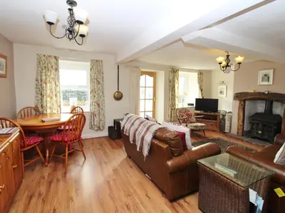 a living room with a couch and a table at 2 Mellfell View in Penrith