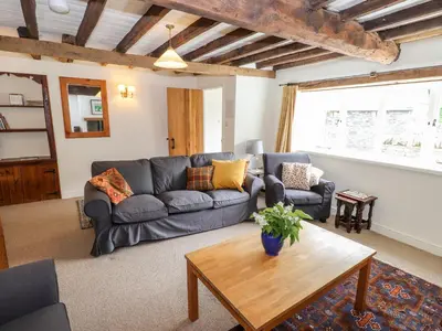 a living room with a couch and a table at Two Town End in Penrith