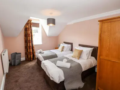 a bedroom with two beds and a window at Oakhurst in Keswick