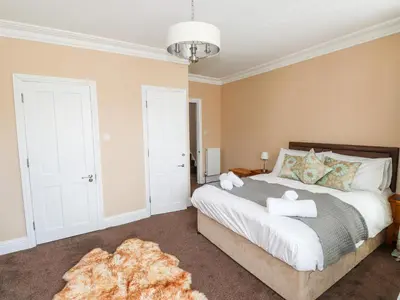 a bedroom with a large white bed and a rug at Oakhurst in Keswick