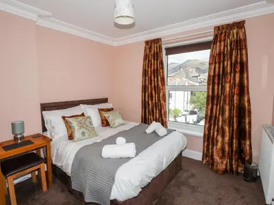 a bedroom with a bed and a large window at Oakhurst in Keswick