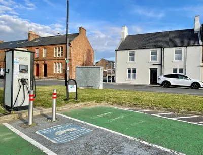a gas pump in a parking lot with a car at Number 53 in Girvan