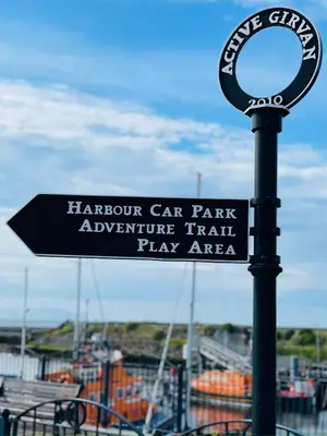 a sign for a harpoon car park appliance train play area at Number 53 in Girvan
