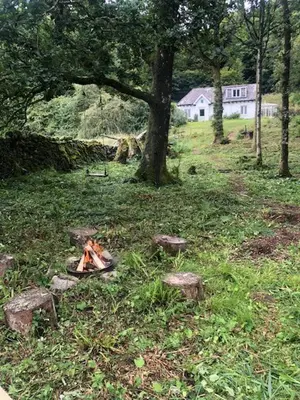 a camp fire in the grass in a field at Bar Hill Lodge in Gatehouse of Fleet